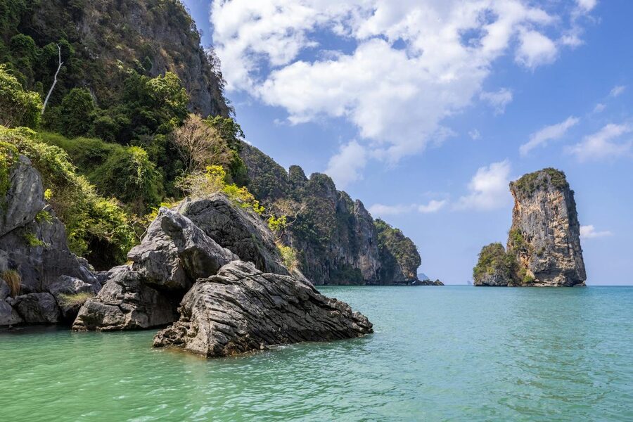 Rocky limestone formations on Ao Nang Beach in Krabi Thailand