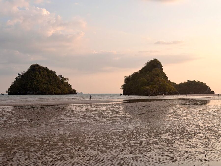 Golden hour sunset at Ao Nang Beach with limestone formations in Krabi Thailand