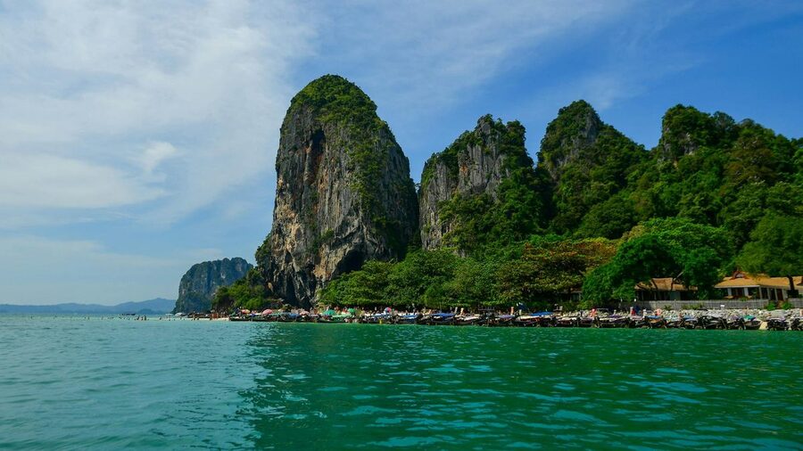 Panoramic view of Krabi limestone cliffs with turquoise water and green vegetation