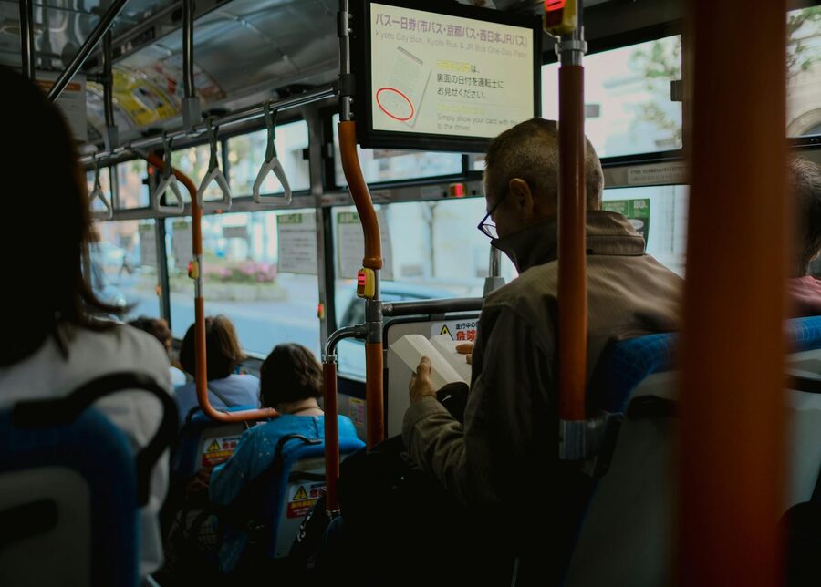 Passengers reading on a Kyoto sightseeing bus