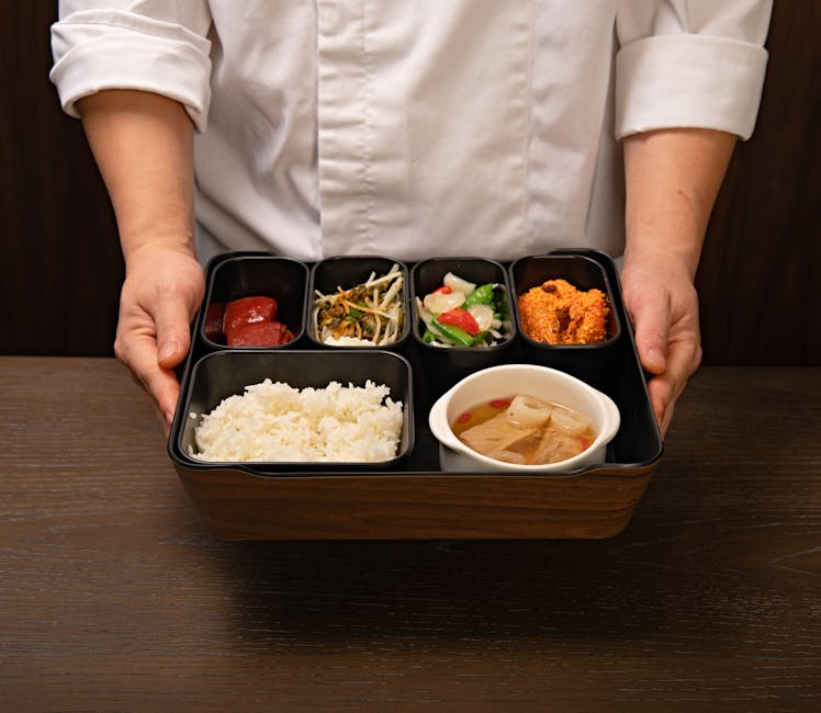 Chef presenting a traditional bento box