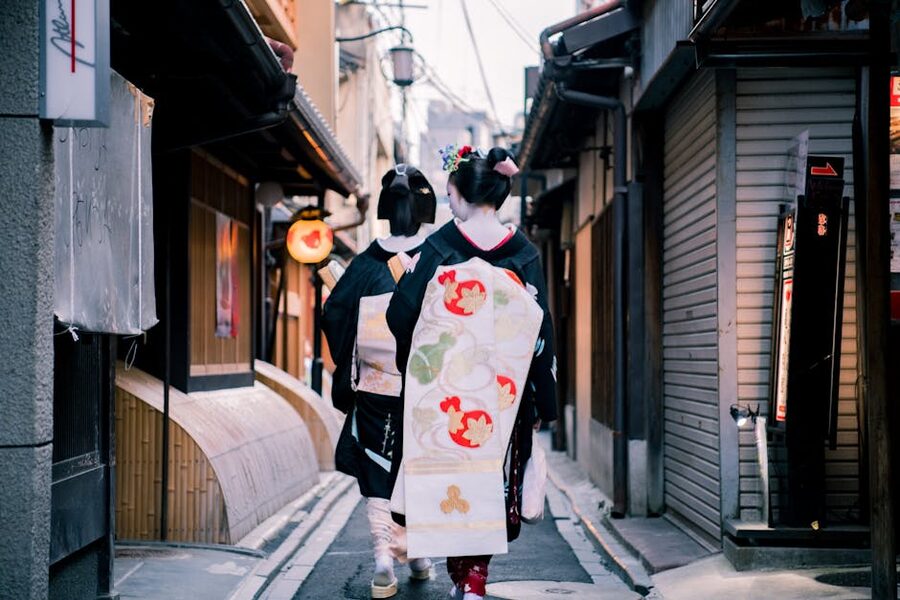 Women in kimono walking a narrow Gion alley in Kyoto