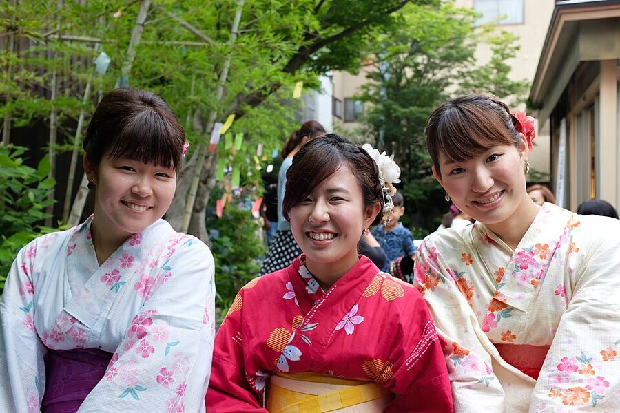 Two women in kimono eating matcha ice cream in Kyoto