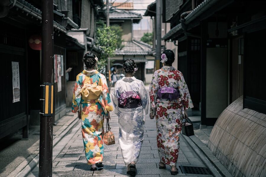 Three women in colorful kimonos on a Kyoto traditional street