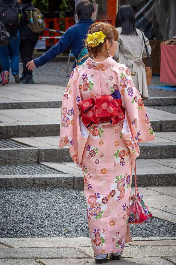 Women in kimono walking Kyoto street food area
