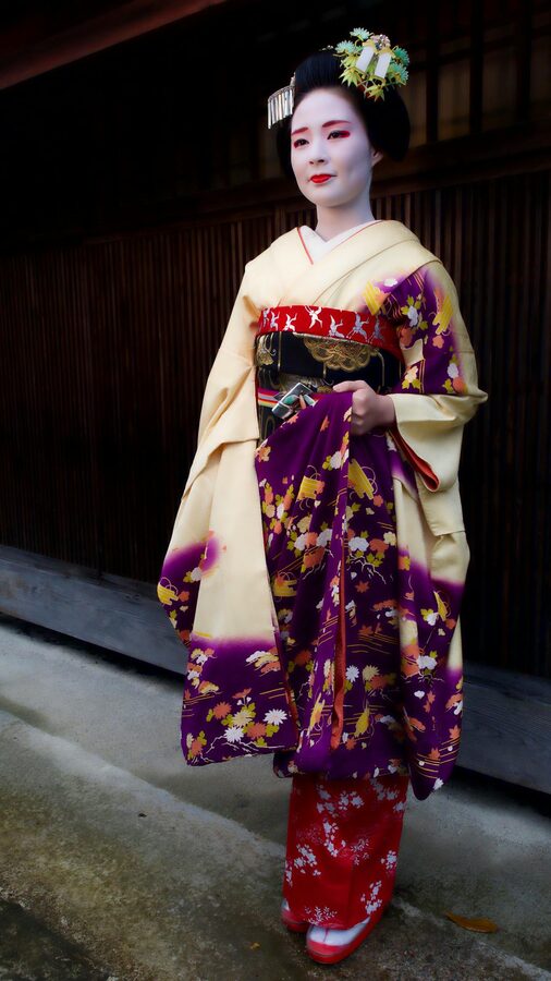 Maiko in kimono walking Gion district Kyoto