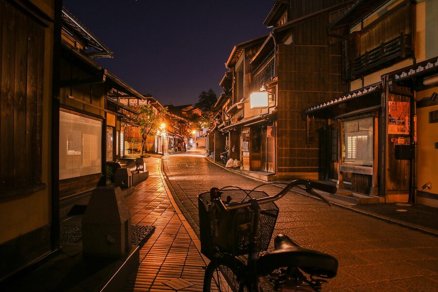 Kyoto neighborhood street at night with bicycle