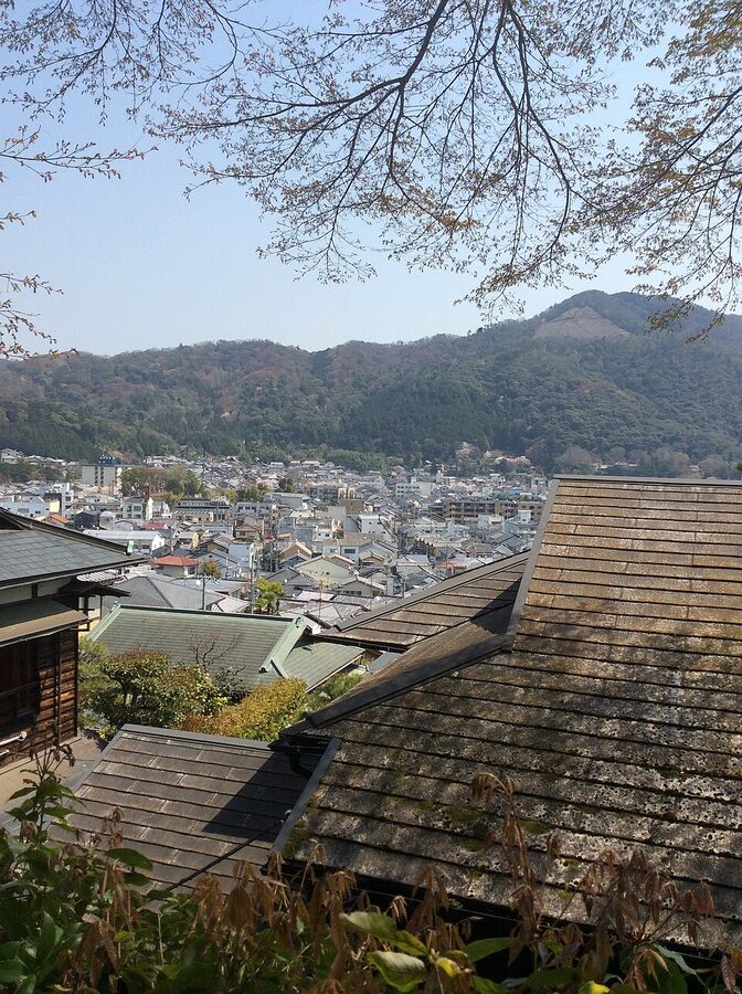 Guided walking tour group climbing a Kyoto hill