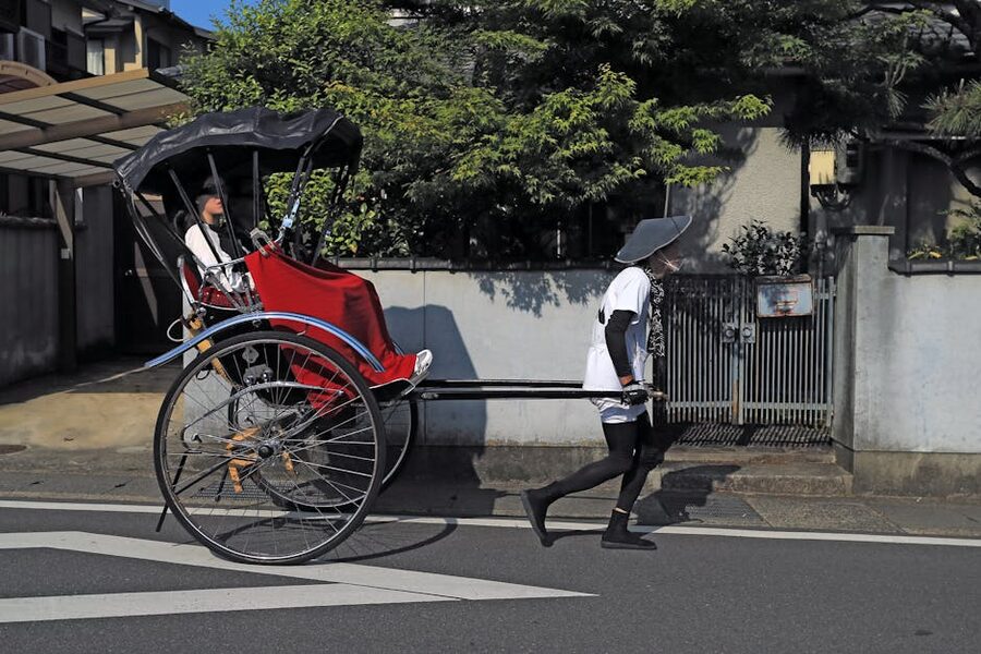 Japanese rickshaw shafu pulling a passenger