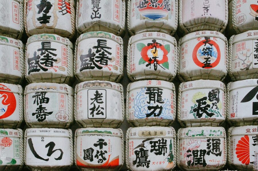 Traditional Japanese sake barrels with calligraphy and art