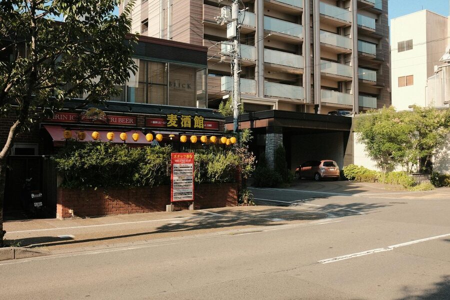 Japanese izakaya exterior with lanterns at night