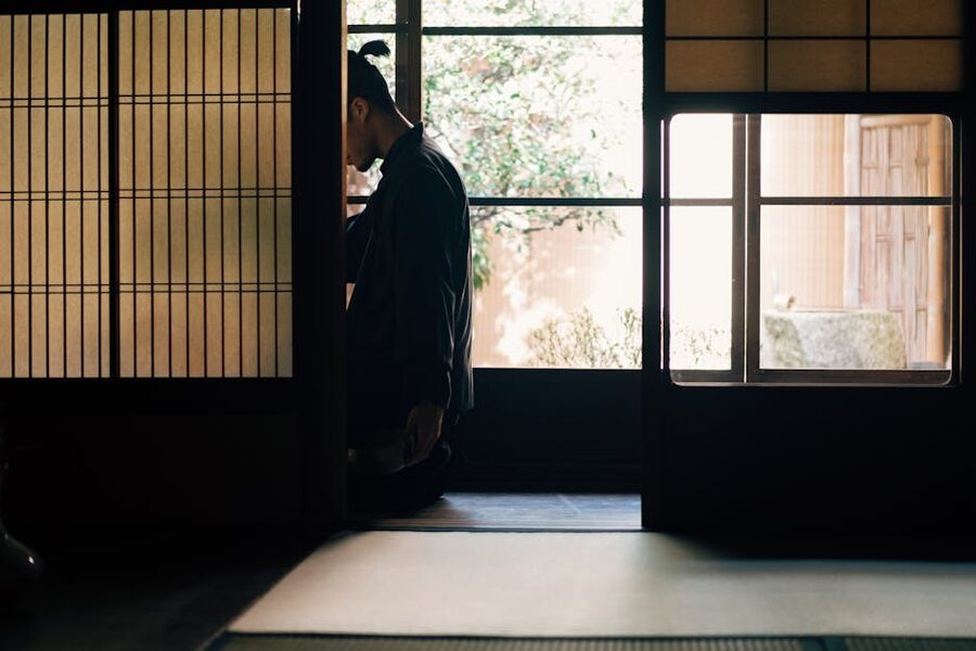 Person meditating in a traditional Japanese tatami room
