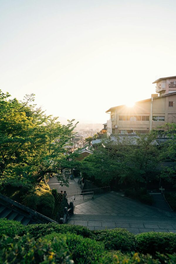 Charming Kyoto street at sunrise with traditional wooden buildings and greenery