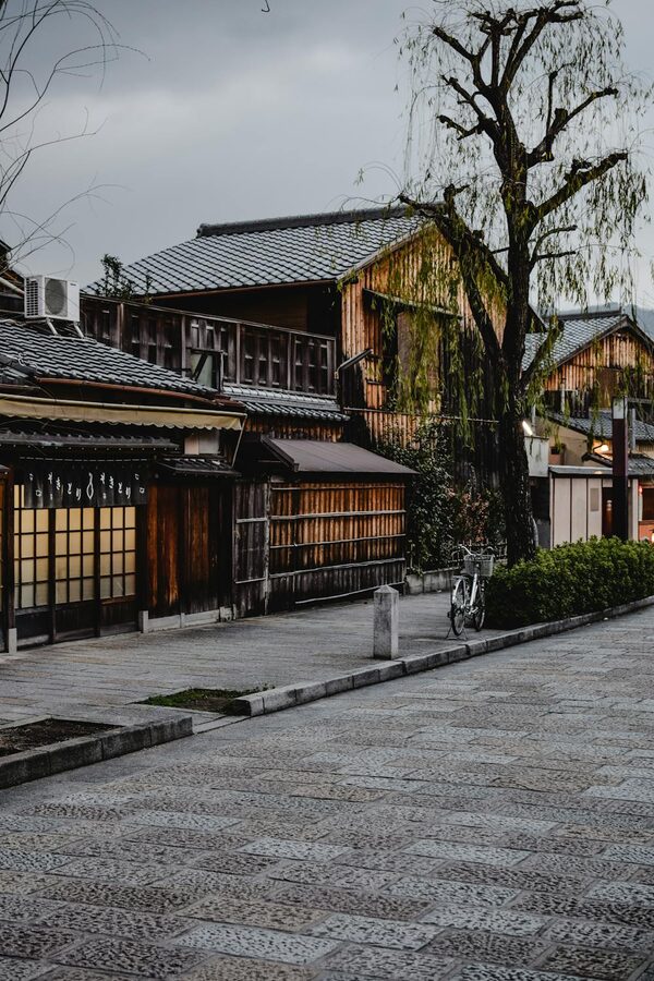 Traditional wooden houses lining a quiet narrow street in Kyoto