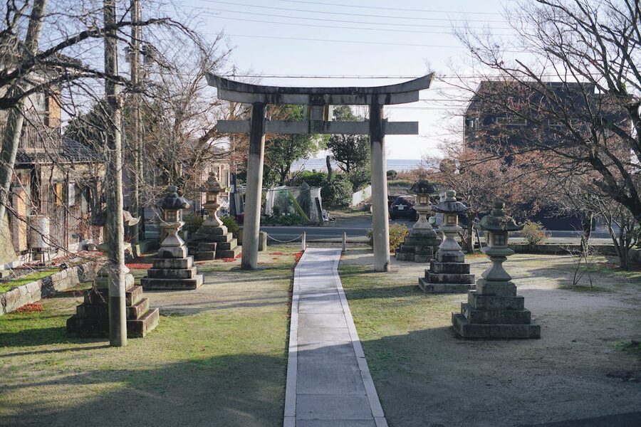 Tranquil Japanese garden with a traditional shrine entrance and stone lanterns