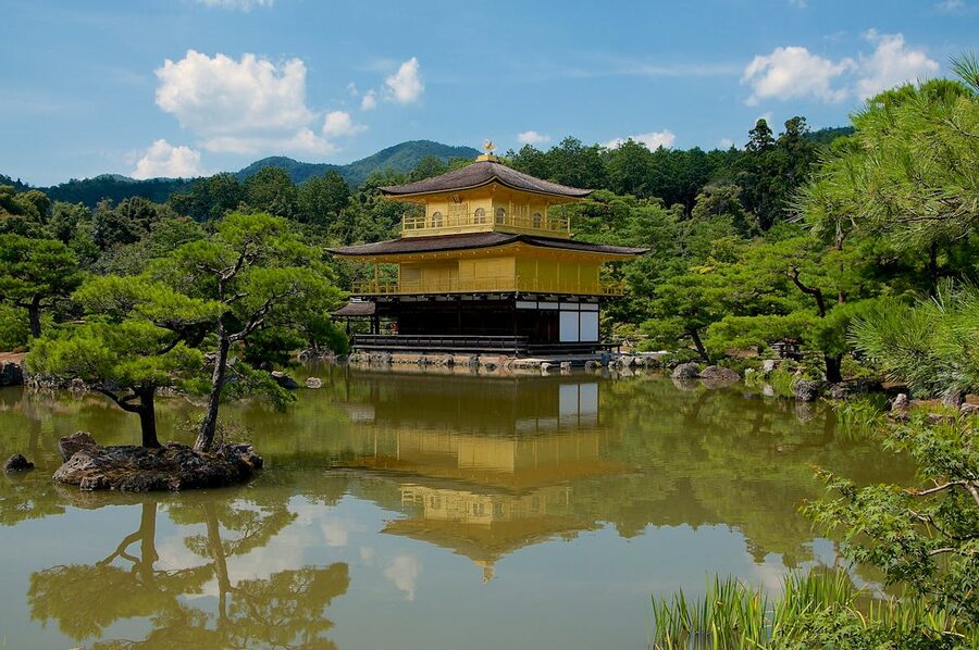 Kinkaku-ji Golden Pavilion reflected in a tranquil pond surrounded by greenery in Kyoto