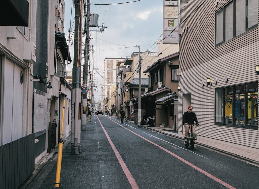 Cyclist riding through a tranquil Kyoto street