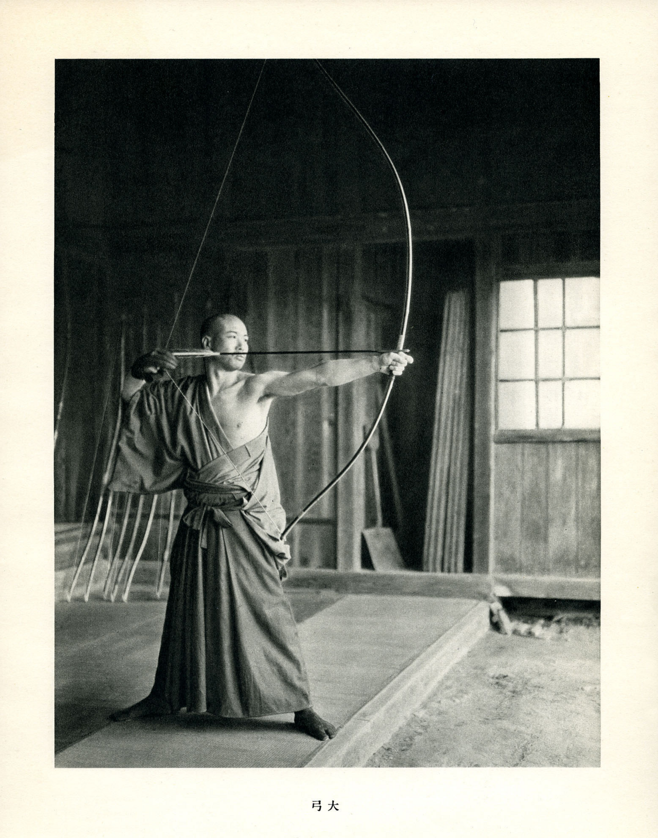 Japanese kyudoka high level expert draws a daikyu longbow in full form
