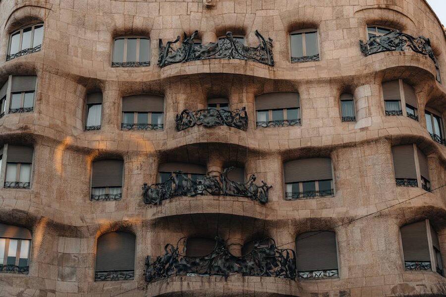 Curving stone balconies of Casa Mila with twisted wrought iron railings