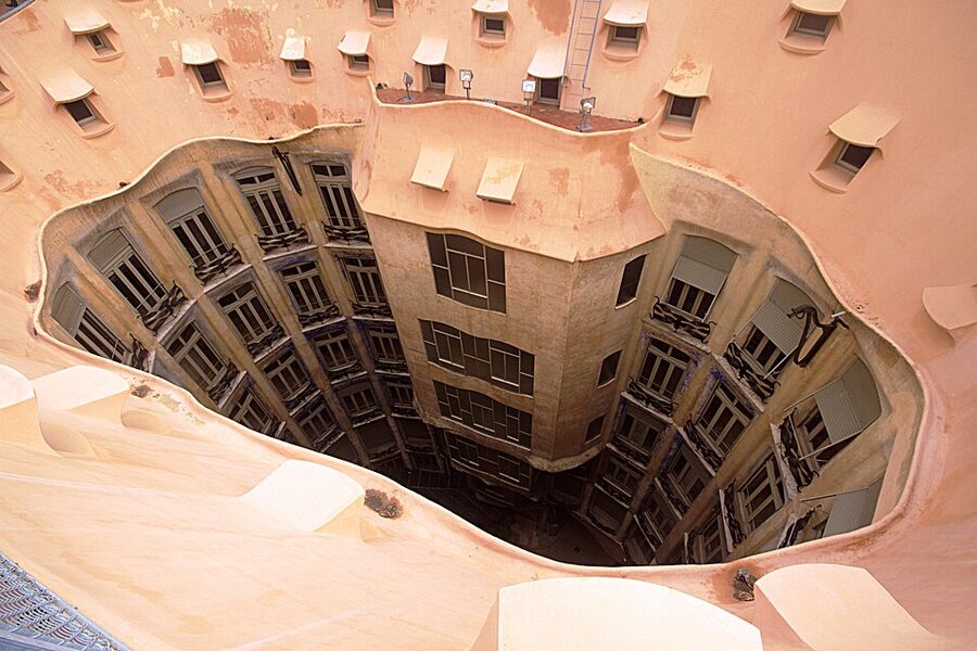 Internal courtyard light well of Casa Mila with painted walls