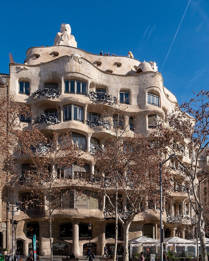 La Pedrera Casa Mila illuminated at night on Passeig de Gracia