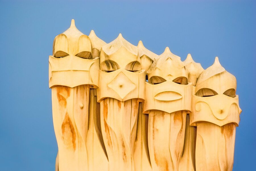 La Pedrera rooftop with cluster of helmeted chimneys against blue sky