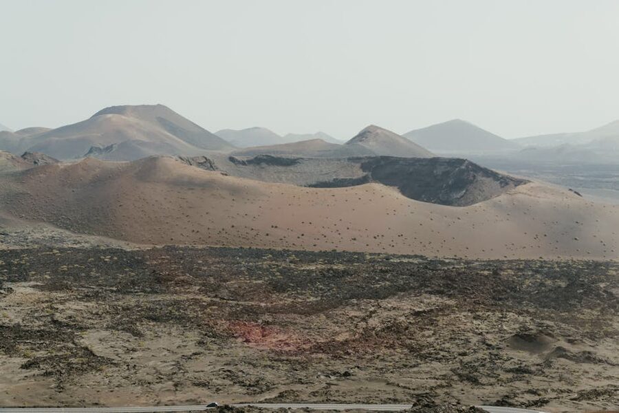 Lanzarote volcanic terrain in Timanfaya area with reddish cones