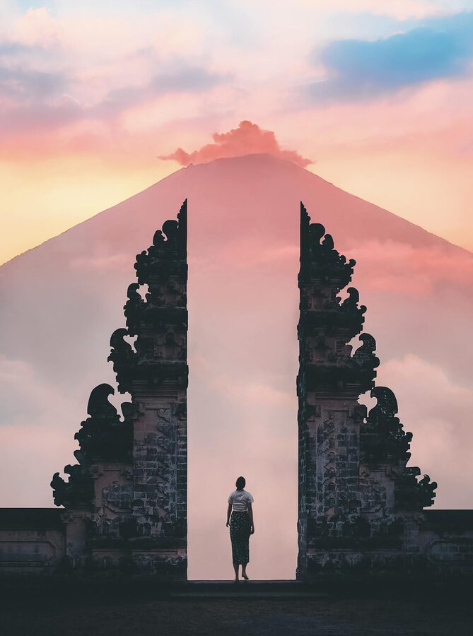 A single visitor at Lempuyang Temple gate just after sunrise