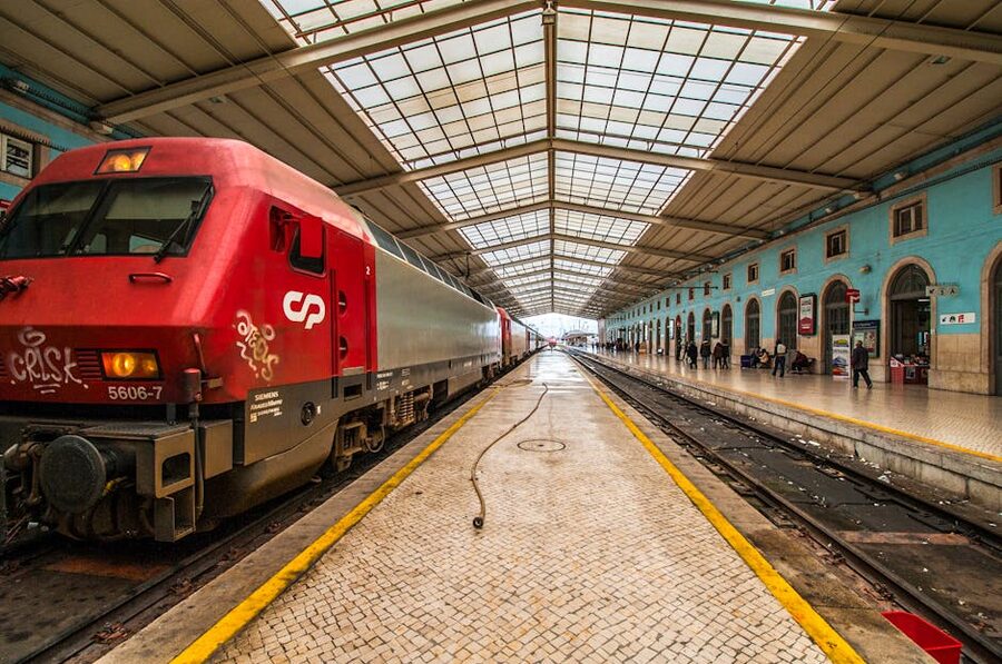 Red passenger train at Lisbon Rossio Railway Station platform