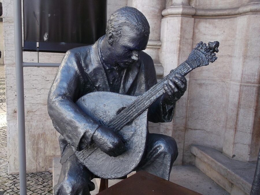Fado singer with guitar statue Lisbon