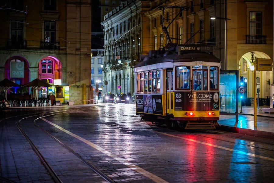 Lisbon yellow tram at night illuminated