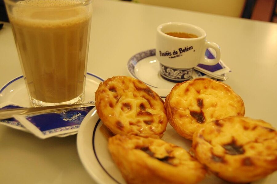 Pastel de nata pastry at Pasteis de Belem in Lisbon with cinnamon