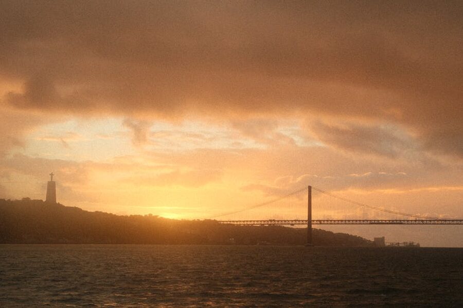 25 de Abril Bridge and Cristo Rei statue at sunset, Lisbon