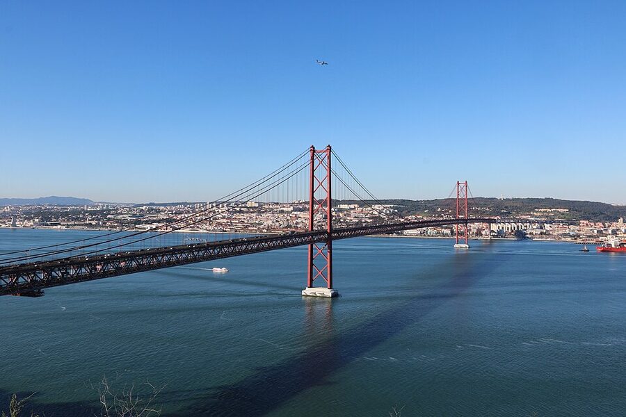 Cristo Rei statue with the 25 de Abril Bridge in the foreground, Lisbon