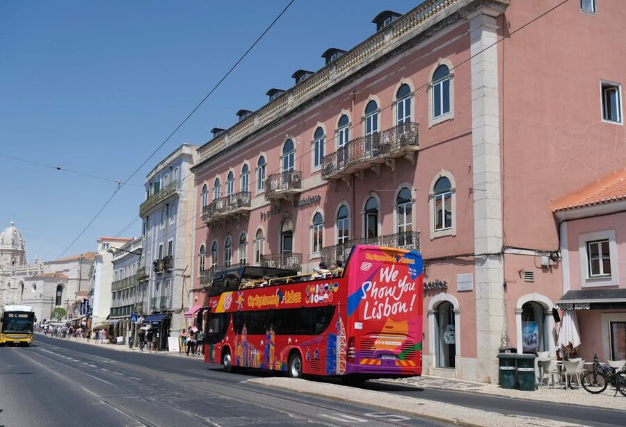 Tour bus on a historic Lisbon street with cobblestone paving