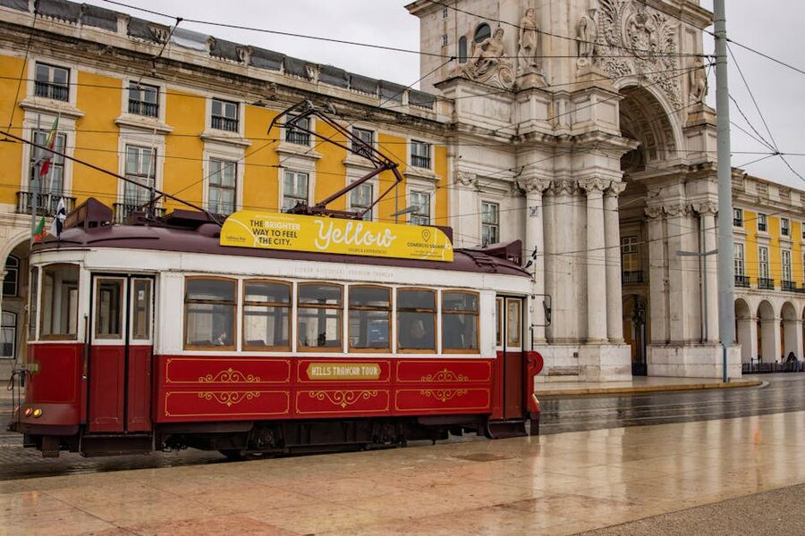 Lisbon yellow tram in front of the Arco da Rua Augusta