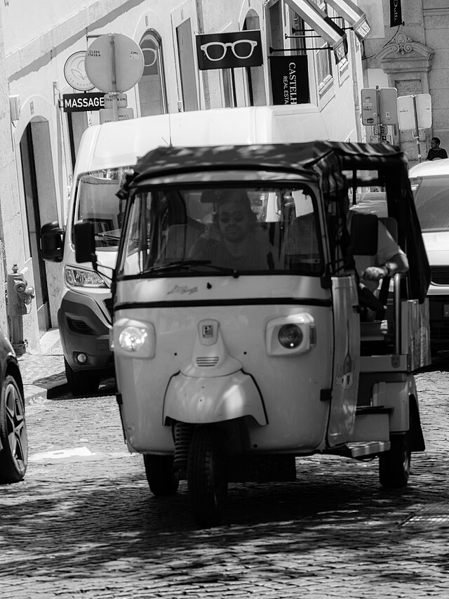 Tuk tuk in Lisbon city centre on a sunlit street