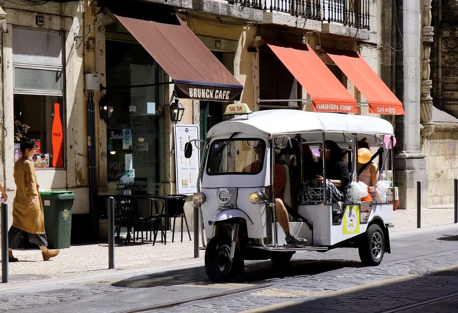 White tuk-tuk in Lisbon historic center