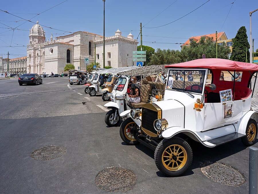 Lisbon tuk-tuks parked in front of Jeronimos Monastery in Belem