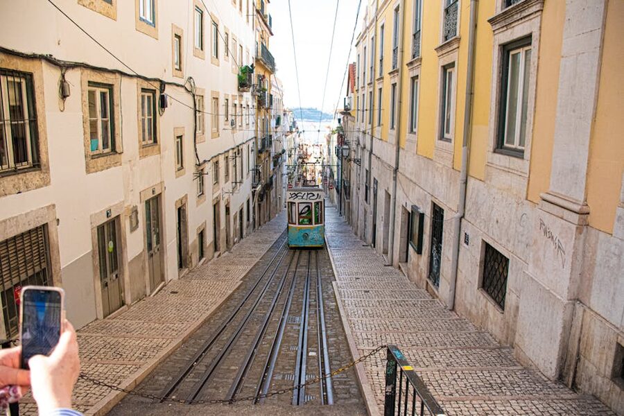Lisbon tram on a steep historic street with tuk-tuk-friendly width