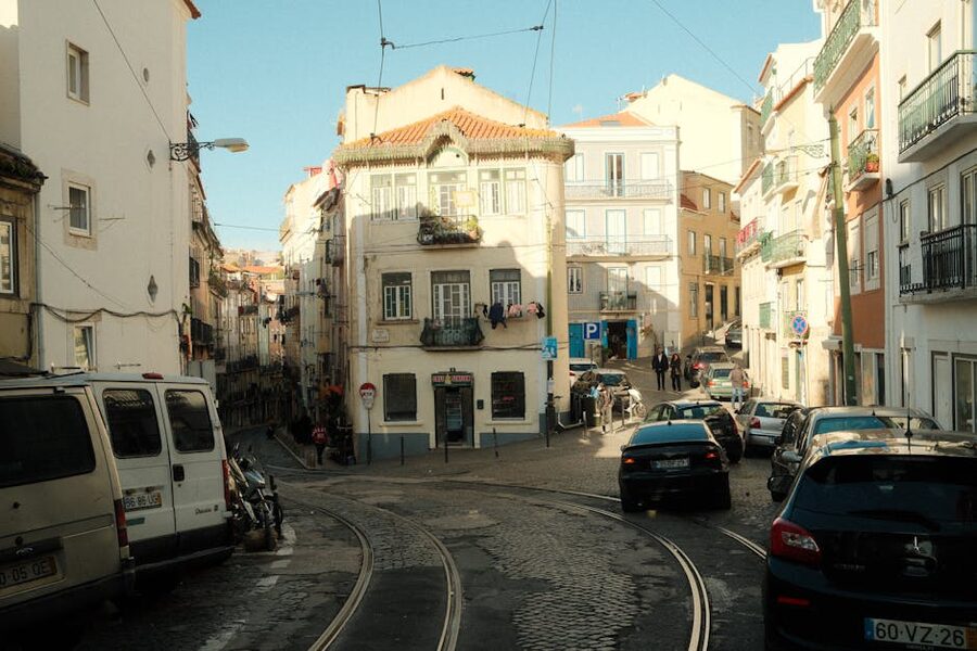 Lisbon street with yellow trams cobblestones