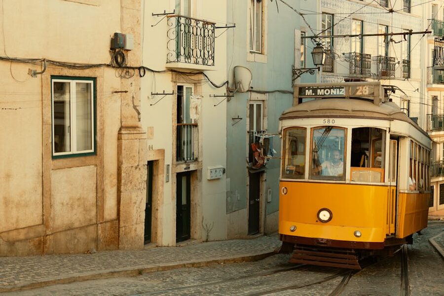 Yellow tram on Lisbon cobblestone street