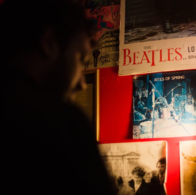 Vintage music gig posters on a red wall