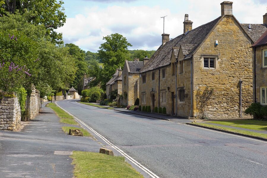 Honey stone village street with limestone walls and slate roofs
