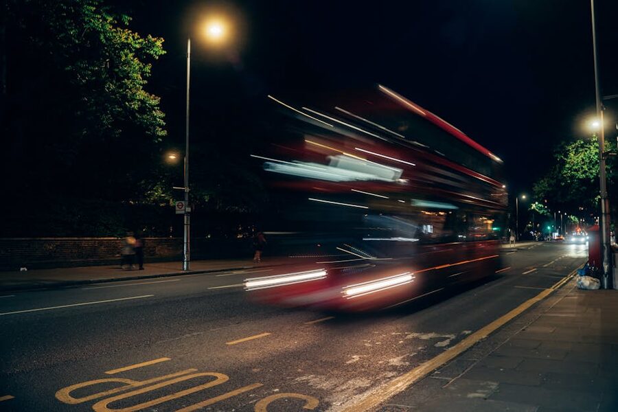 Blurred London double-decker speeding past at night