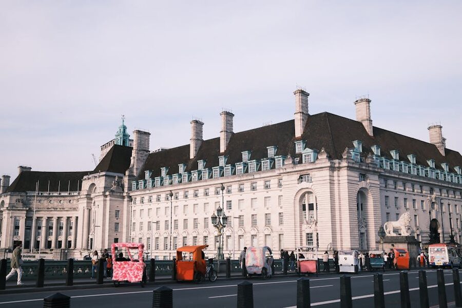 County Hall London exterior with rickshaws and tourists on the South Bank