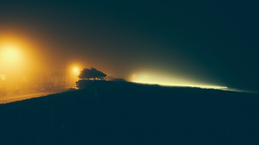 Foggy night street with lamp posts London winter atmosphere
