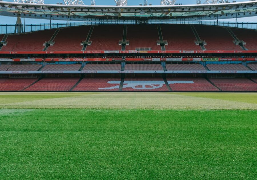 Empty stands and football pitch at Emirates Stadium London