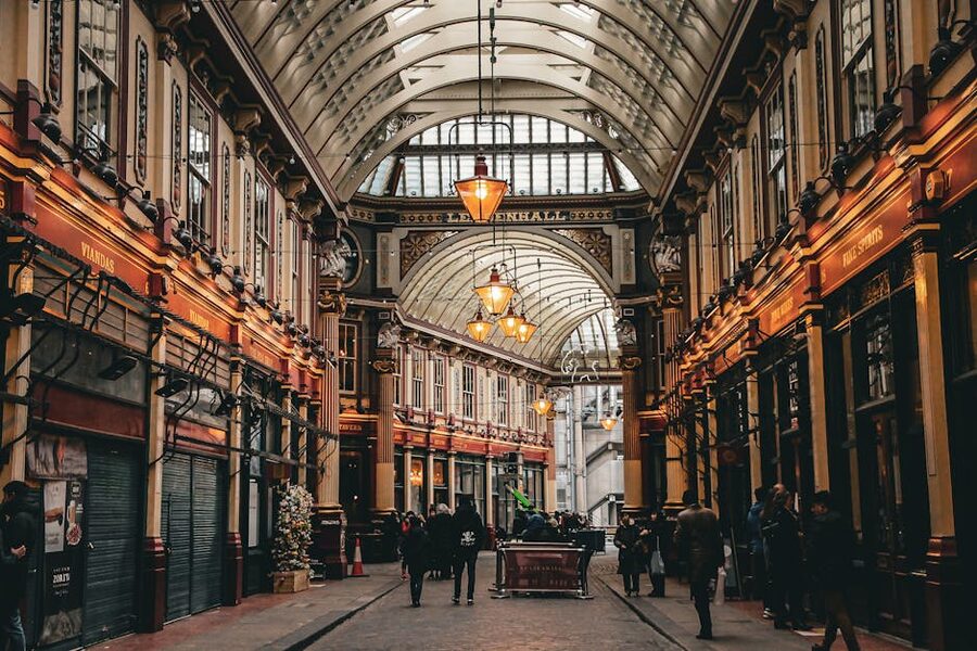 Tourists under Victorian lamps at Leadenhall Market London