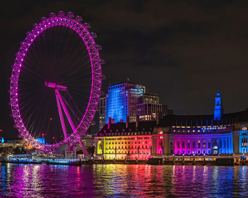 London Eye lit purple over the River Thames at night